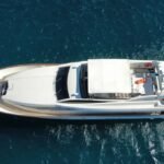 Aerial view of a 100 ft superyacht with flybridge and teak decks