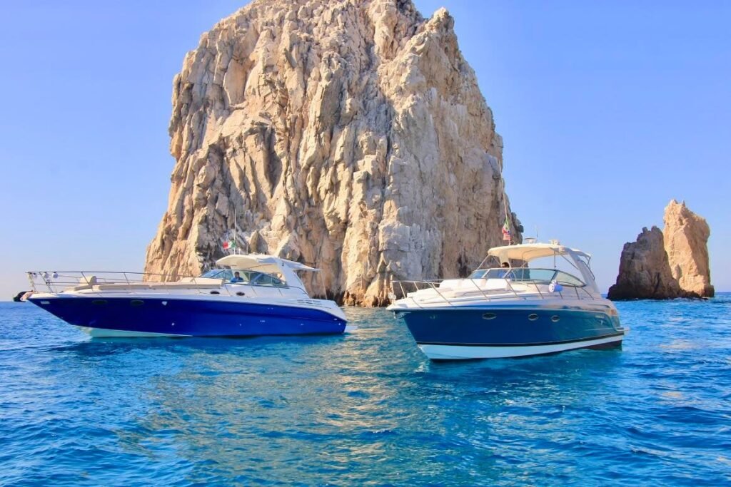 Two private yachts anchored by the Arch in Cabo San Lucas