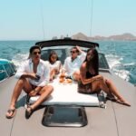 Couple relaxing on the bow of a 46 ft yacht in Cabo